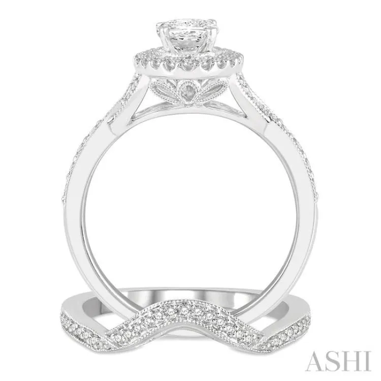 1 1/10 ctw Free Form Shank Round Cut Diamond Bridal Set With 1 ctw Oval Cut Engagement Ring and 1/10 ctw Curved Center Wedding Band in 14K White Gold